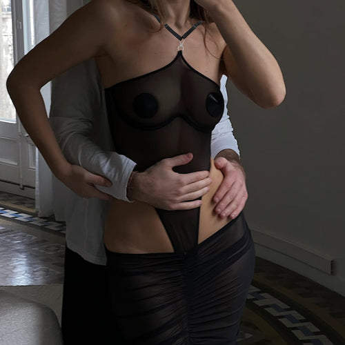 Intimate boudoir mirror reflection featuring the KissKismet sheer black mesh halter bodysuit and skirt.