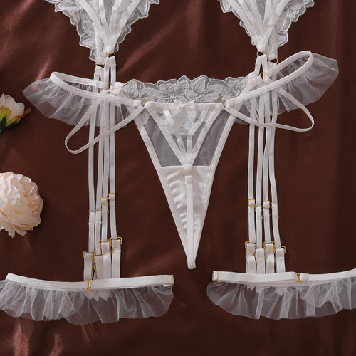 Floral embroidered bridal lingerie set with garter belt and ruffle straps, white sheer lace intimate apparel for wedding night.