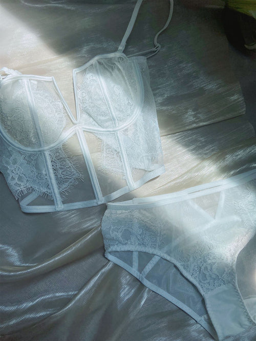 KissKismet angelic white eyelash lace lingerie set. Features a deep V-wire longline bustier with a unique double back closure and a matching sheer mesh panty, perfect for bridal boudoir and honeymoon romance.