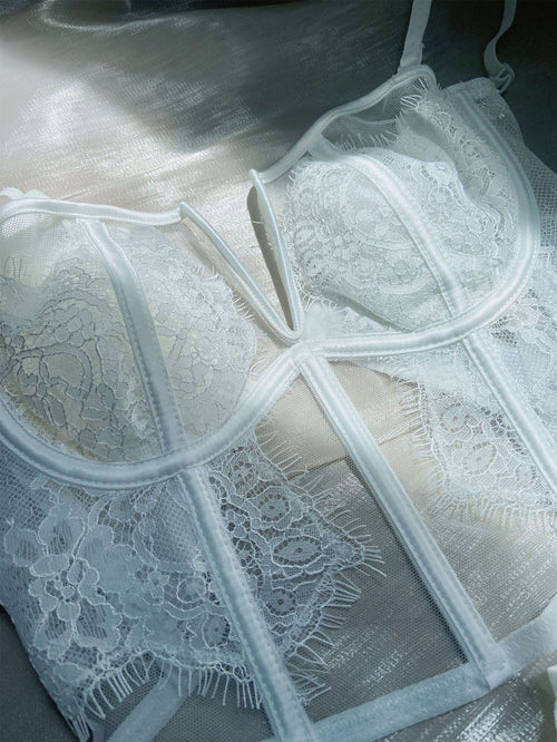 KissKismet angelic white eyelash lace lingerie set. Features a deep V-wire longline bustier with a unique double back closure and a matching sheer mesh panty, perfect for bridal boudoir and honeymoon romance.