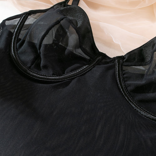 Close-up flat lay of the black bodysuit, focusing on the structured underwire mesh cups and panel stitching.