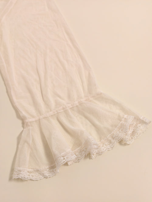 Flat lay detailing the elegant ruffled lace hemline of the modal fairy nightgown.