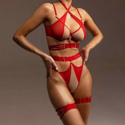 Front view of a model wearing a bold red strappy sheer mesh lingerie set with a waist harness and thigh garters.