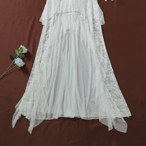 Flat lay detailing the flowing sheer mesh fabric and the romantic white lace ruffled hem of the skirt.   