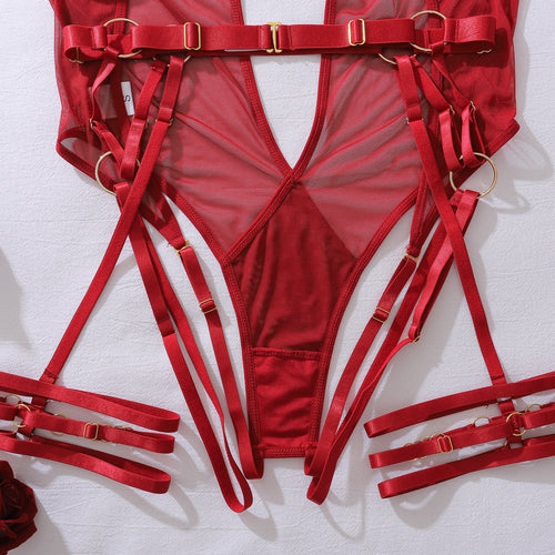 KissKismet deep red sheer mesh lingerie bodysuit featuring a plunging halter neckline, harness-style strapping with gold-tone O-rings, and attached adjustable leg garters.