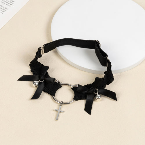 Angled flat lay of the black elastic thigh garter showing the adjustable slider strap and detailed silver hardware.