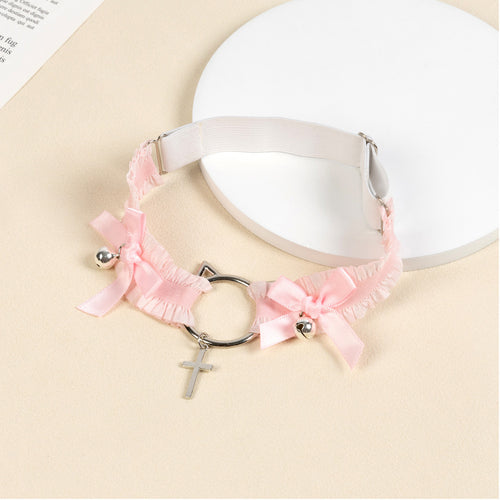 Angled flat lay of the pink elastic thigh garter showing the adjustable slider strap and detailed silver hardware.