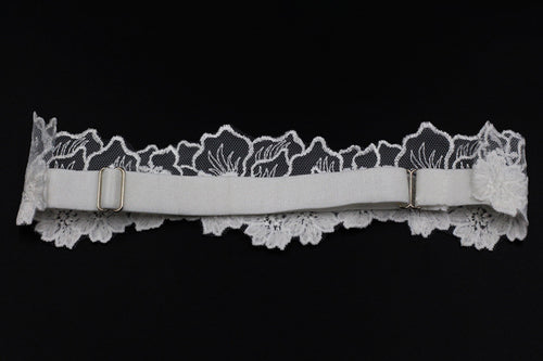 Back view flat lay of the white lace bridal garter showing the adjustable elastic strap.