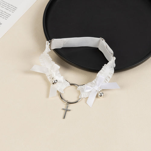 Angled flat lay of the white elastic thigh garter showing the adjustable slider strap and detailed silver hardware.