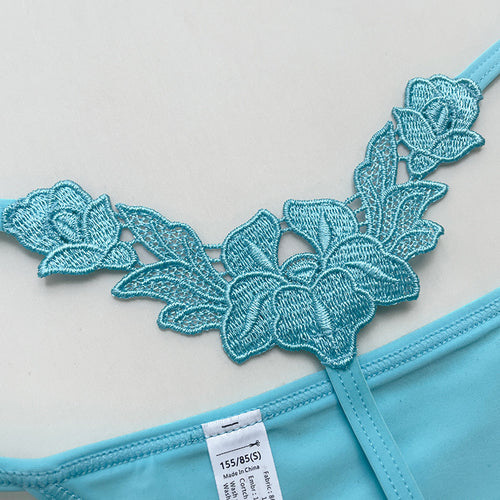 Close-up detail of the heavy-stitch floral embroidery applique on the back of the KissKismet G-string.