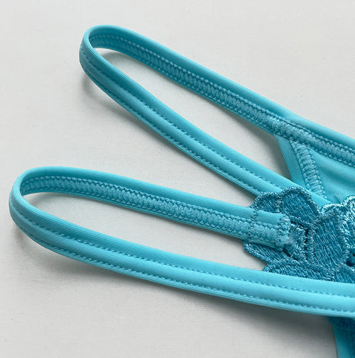 Close-up view of the ultra-soft, high-stretch elastic side strings on the pearl G-string.