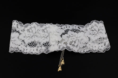 Another flat lay view of the bridal garter, showcasing the seamless handmade lace weave and tassel detail.
