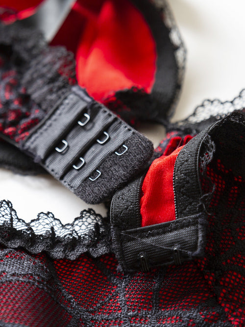 Close-up of the adjustable hook-and-eye back closure on the gothic lingerie bodysuit.