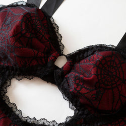 Close-up of the wire-free bust area on the gothic spiderweb bodysuit with a central O-ring and black lace trim.