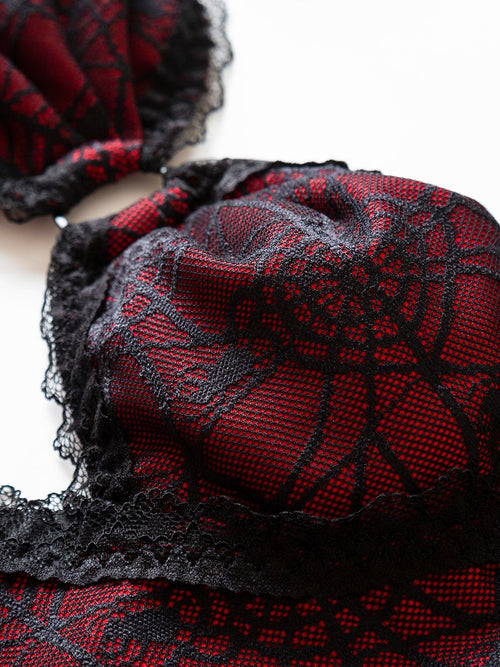 Detailed view of the wire-free soft cups covered in black spiderweb lace.