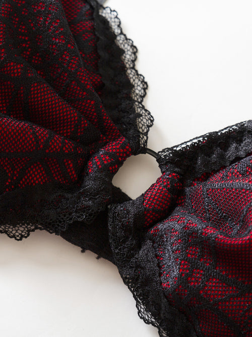 Close-up of the sexy midriff cutout and delicate black scalloped lace edging on the gothic bodysuit.