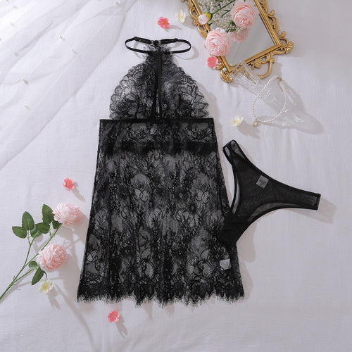 Flat lay of black eyelash lace halter chemise and thong set