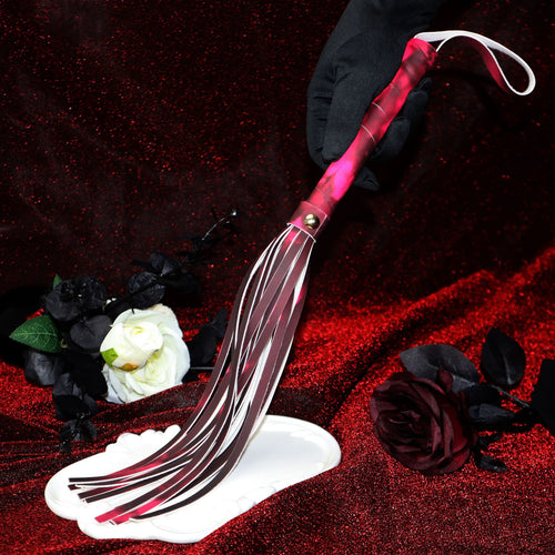 Close-up of thermal color-changing tassel whip with black glove