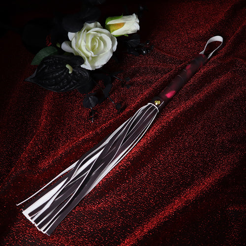 Flat lay view of color-changing leather tassel whip
