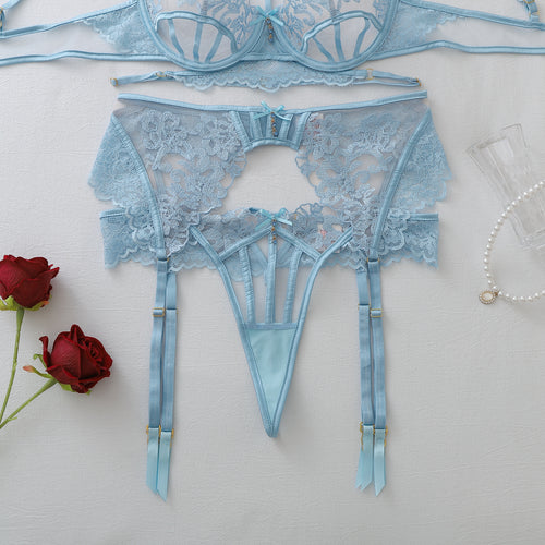 Flat lay close-up of the light blue embroidered garter belt and matching strappy thong.