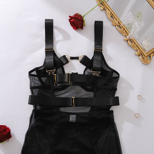 Close-up flat lay of the secure back hook closures and adjustable harness straps on the KissKismet black mesh bodysuit.