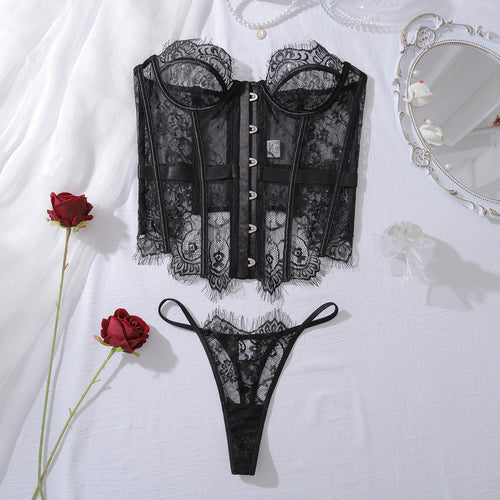 KissKismet Flat lay presentation of the complete 2-piece KissKismet femme fatale set, including the front-hook corset and matching lace thong.