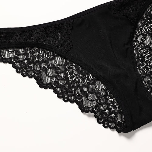 Close-up flat lay detail of the matching KissKismet black panty, highlighting the intricate floral lace and soft scalloped edges.