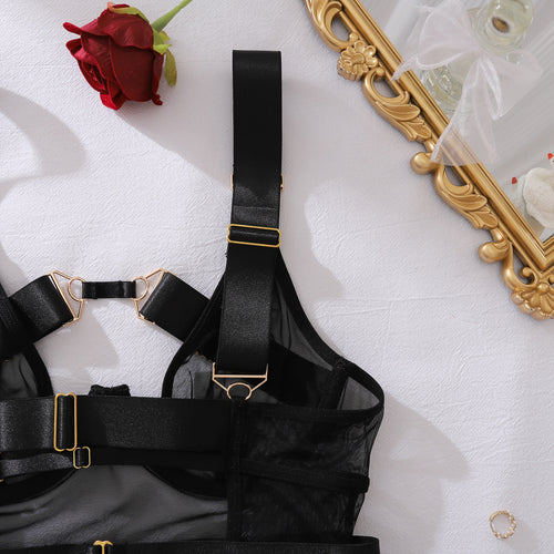 Detail shot of the thick, adjustable shoulder straps and premium gold-tone buckles on the KissKismet harness lingerie set.