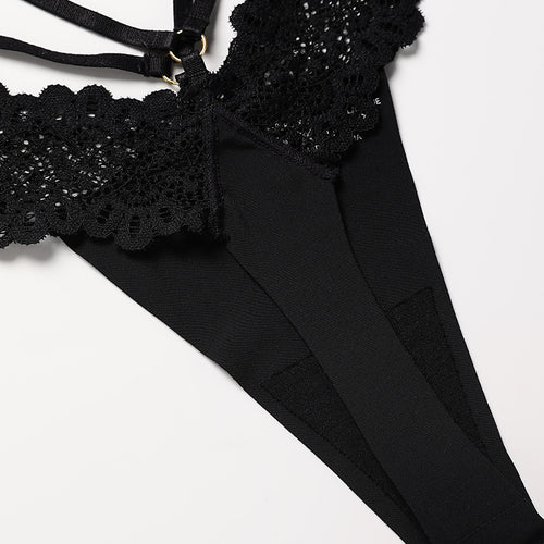 Flat lay view detailing the minimal back construction and soft fabric of the KissKismet noir strappy lace thong.