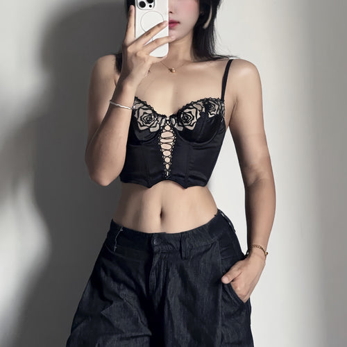 KissKismet black satin longline bustier lingerie set featuring vintage romantic rose embroidery, a seductive lace-up front corset detail, and a matching sheer mesh panty. Perfect for dark coquette aesthetic and lingerie as outerwear.