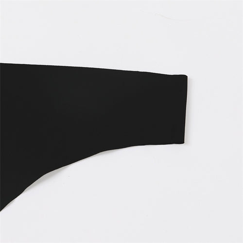 Flat lay presentation of the complete black low-waisted seamless ice silk thong.
