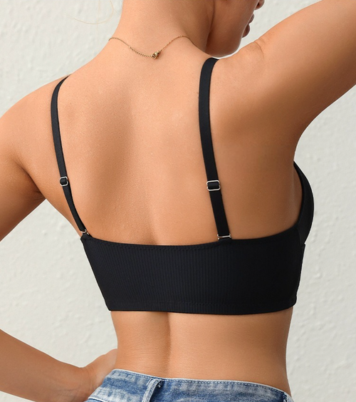 Back view of a model emphasizing the sleek, minimal back design and adjustable straps of the KissKismet ribbed wireless bra.