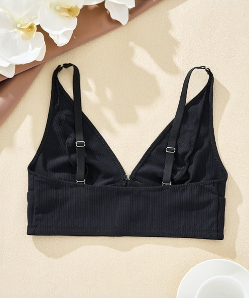 Flat lay view of the bra's back construction, detailing the premium ribbed fabric and fully adjustable sliders.