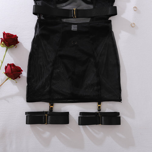 Close-up flat lay of the matching black sheer mesh skirt, featuring an edgy buckle belt waist and attached garter straps.
