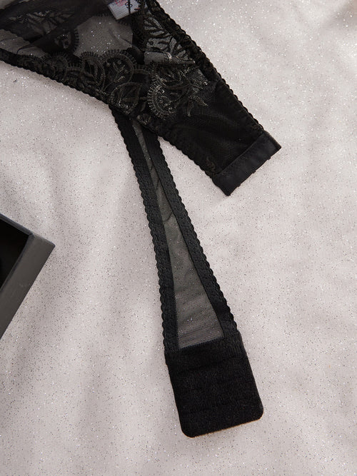 Detailed close-up of the adjustable hook-and-eye back closure on the KissKismet noir floral lace bodysuit, ensuring a custom, flawless fit.