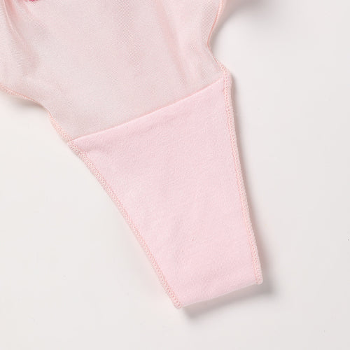 Close-up flat lay detail showing the soft interior lining and seamless finish of the KissKismet blush pink satin thong.