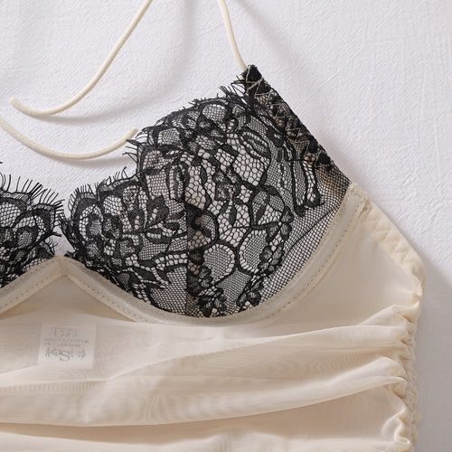Extreme close-up flat lay detailing the delicate black lace splicing over the sheer beige mesh fabric.
