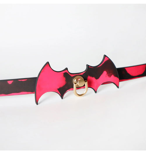 Close-up of the bat design collar glowing red from body heat activation.