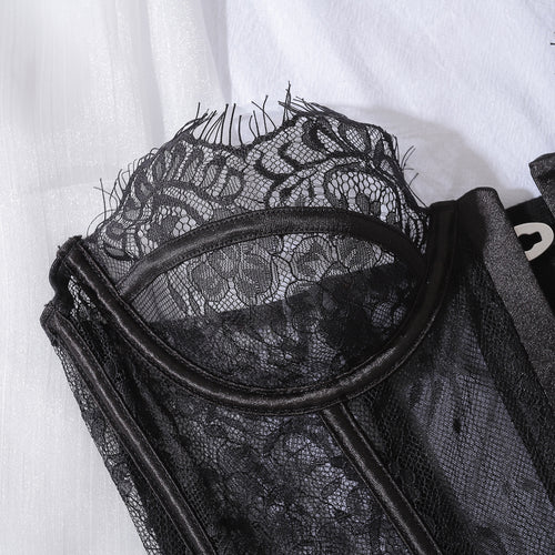 Close-up flat lay detail focusing on the delicate eyelash lace trim along the neckline of the KissKismet shaping corset.
