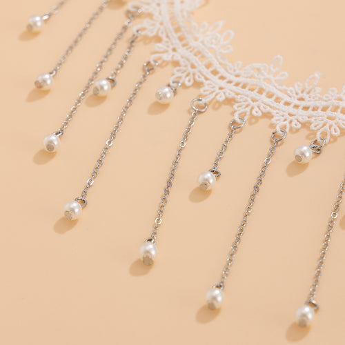 Macro close-up emphasizing the intricate white floral lace trim, silver-tone metal chains, and faux pearl drops.
