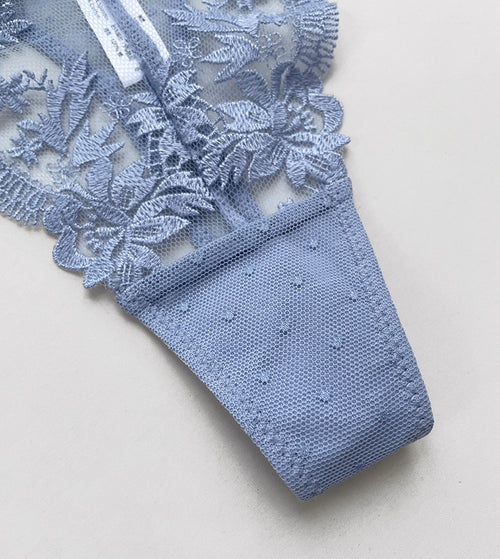 Back flat lay view of the KissKismet dusty blue lace thong, showcasing the minimal coverage G-string design.