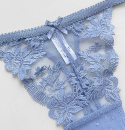 Close-up detail of the exquisite dusty blue floral lace embroidery and elegant center seam on the KissKismet thong.