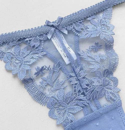 Close-up detail of the exquisite dusty blue floral lace embroidery and elegant center seam on the KissKismet thong.