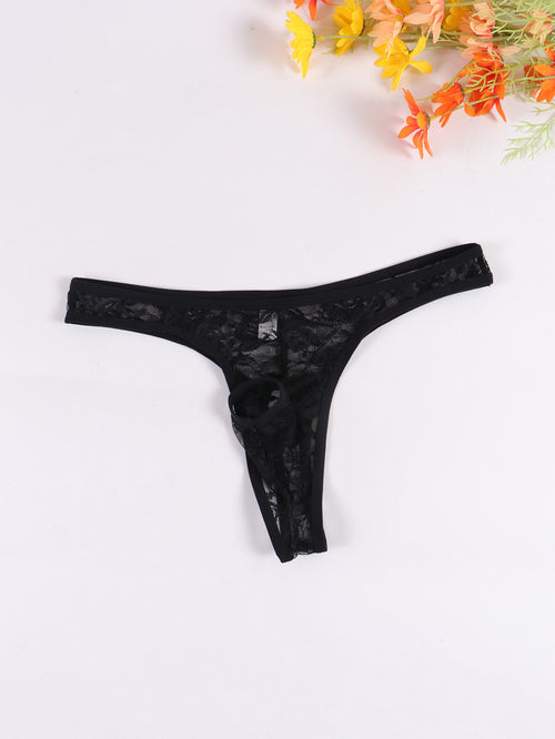 Flat lay view of the front of a black sheer lace men's thong with cut-out detail