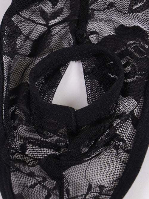 Close-up front view of the circular open-front design on sheer black floral lace men's thong