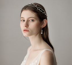 Elegant side profile of a bride in a V-neck lace dress wearing a delicate silver pearl headband during a fine-art photoshoot.