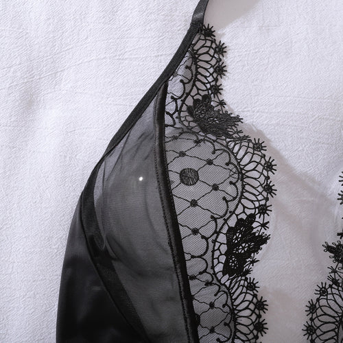Aesthetic flat lay shot of the Ethereal Noir embroidered bodysuit, highlighting the intricate lace patterns and premium craftsmanship.