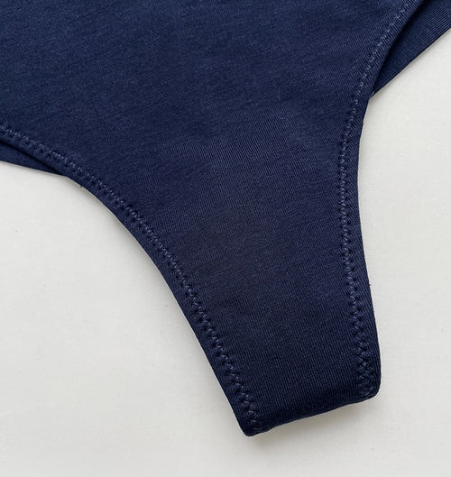 Close-up flat lay view of the back thong strap and soft ribbed texture of the modal cotton fabric.