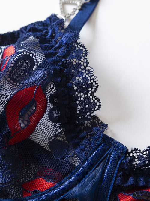Detailed view of the flirtatious side slit and scalloped lace edge on the KissKismet navy blue lip print chemise.
