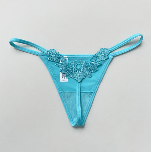 Back flat lay view highlighting the intricate floral embroidery and the distinctive faux pearl beaded string.